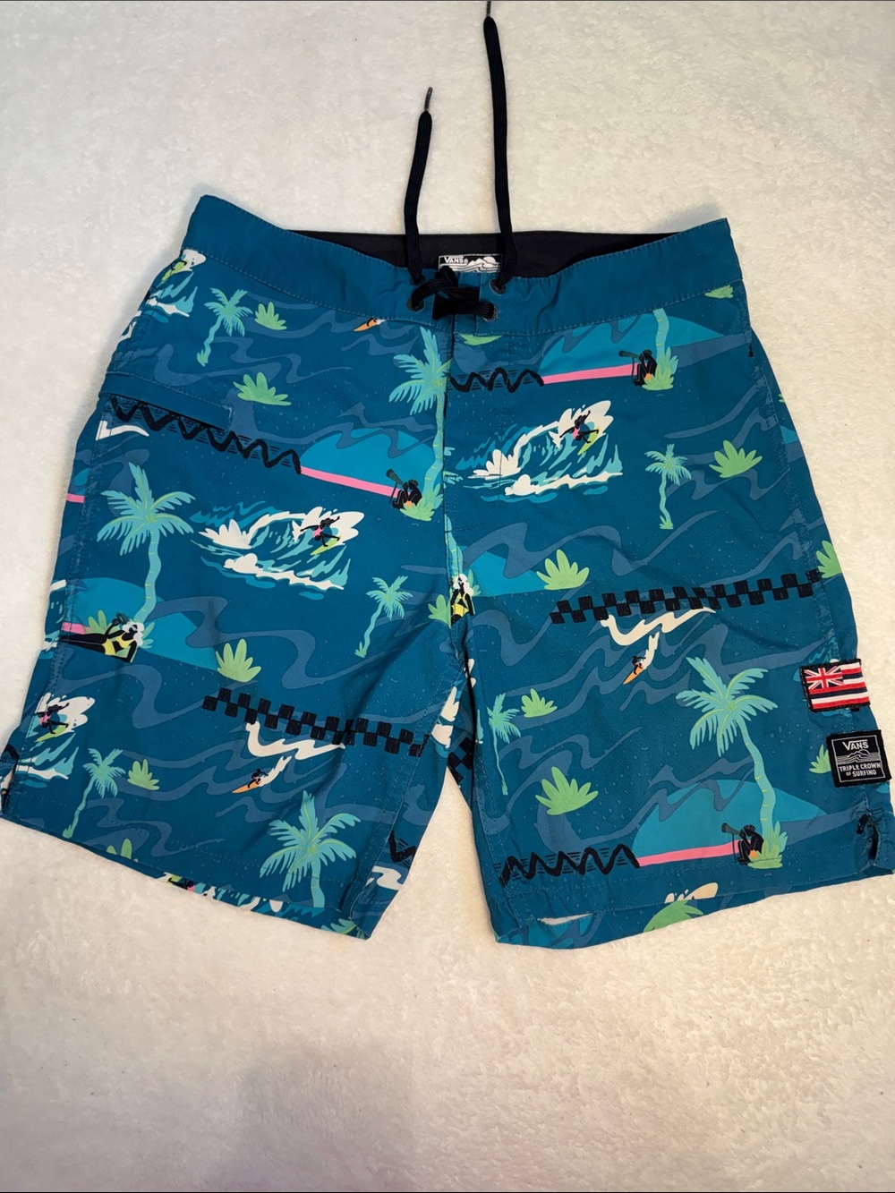 Vans blue patterned board shorts.
